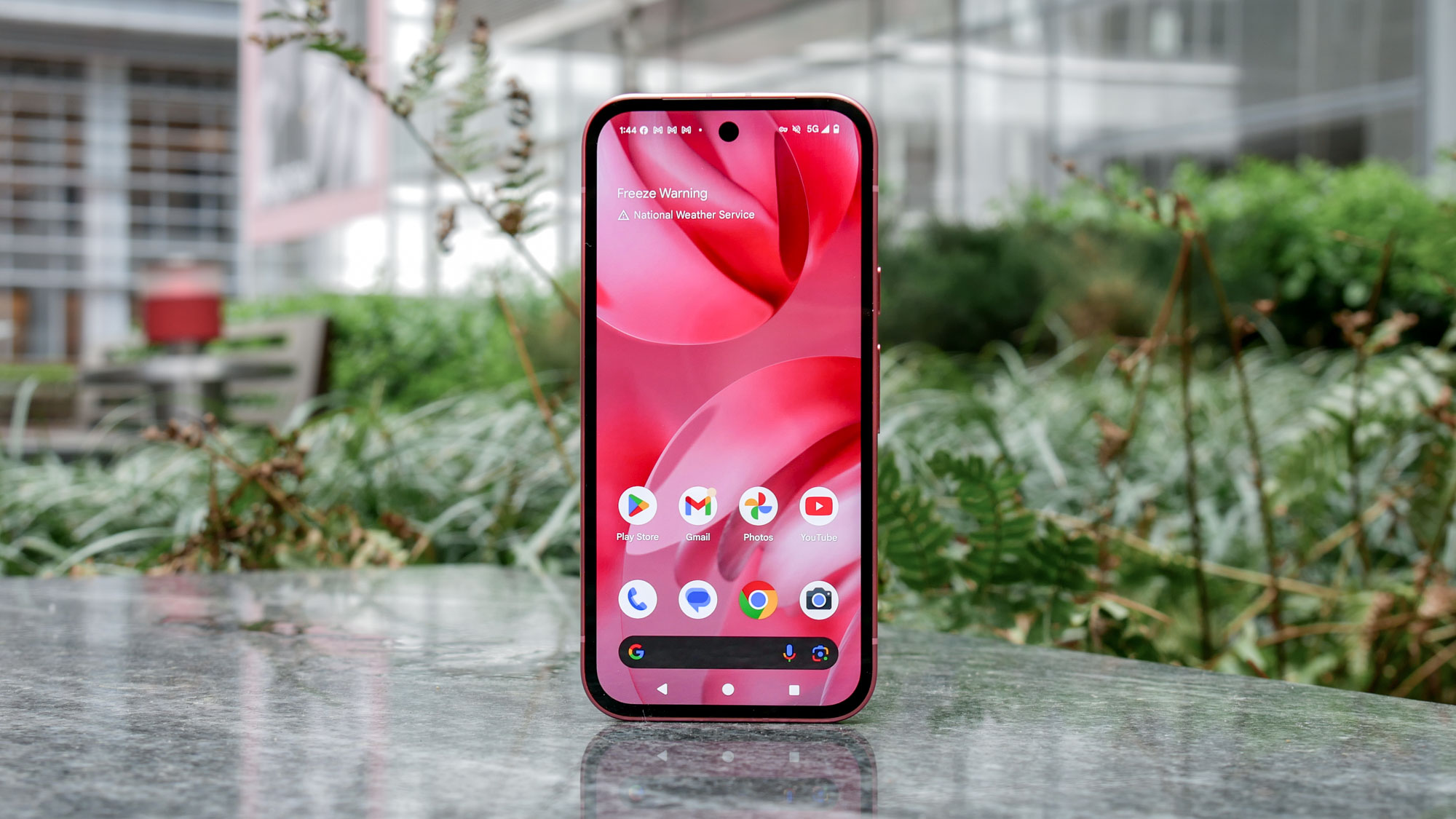 Google Pixel 9a held in the hand.