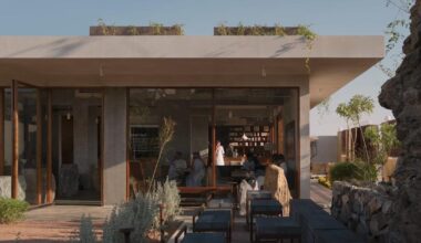 open courtyard organizes café carved into rock in saudi arabia