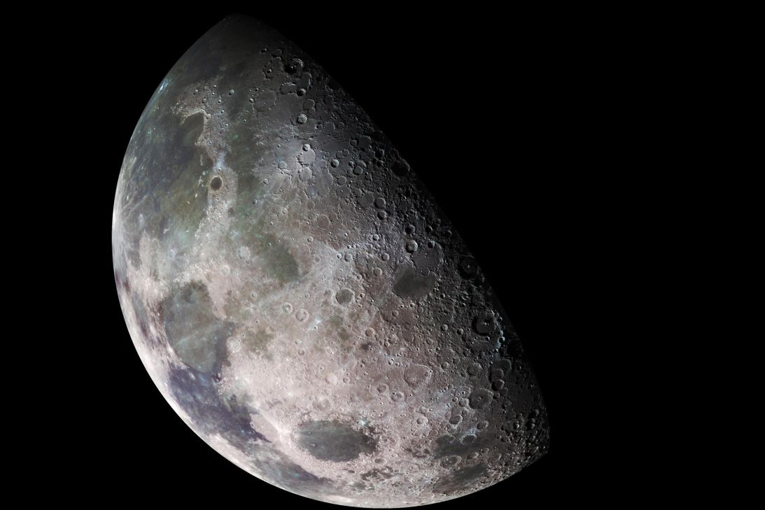 A color mosaic of the moon's north pole region shows dark volcanic regions and craters.