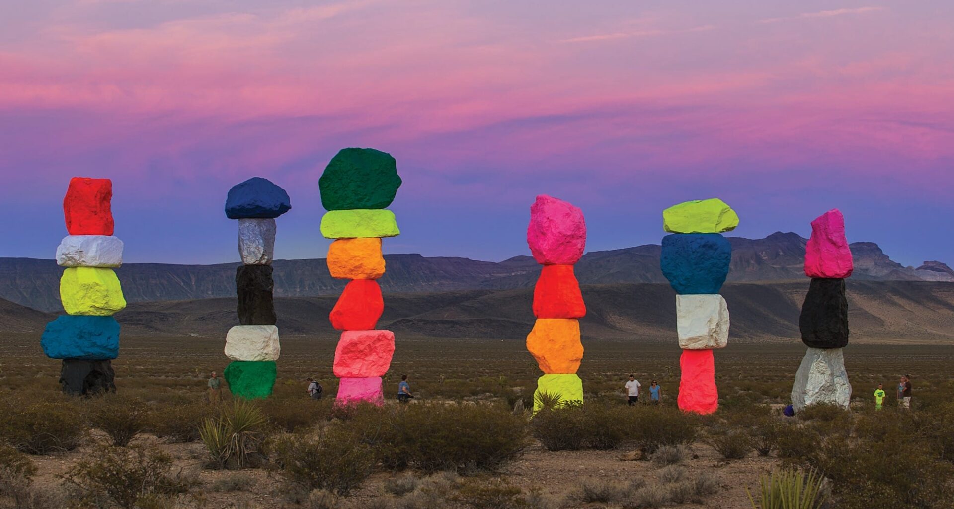 a collection of colorful stone totems by ugo rondinone