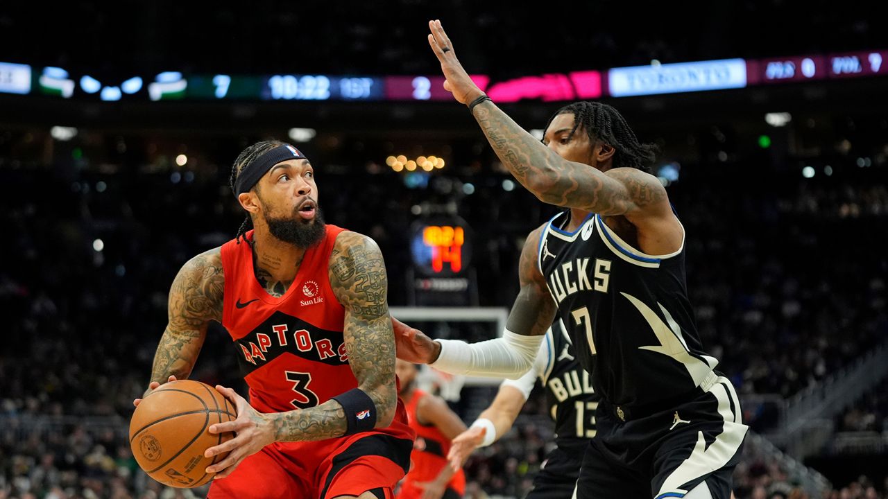 Toronto Raptors' Brandon Ingram looks to shoot against Milwaukee Bucks' Kevin Porter Jr. during the first half of an NBA basketball game Sunday, Feb. 22, 2026, in Milwaukee. (AP Photo/Aaron Gash)