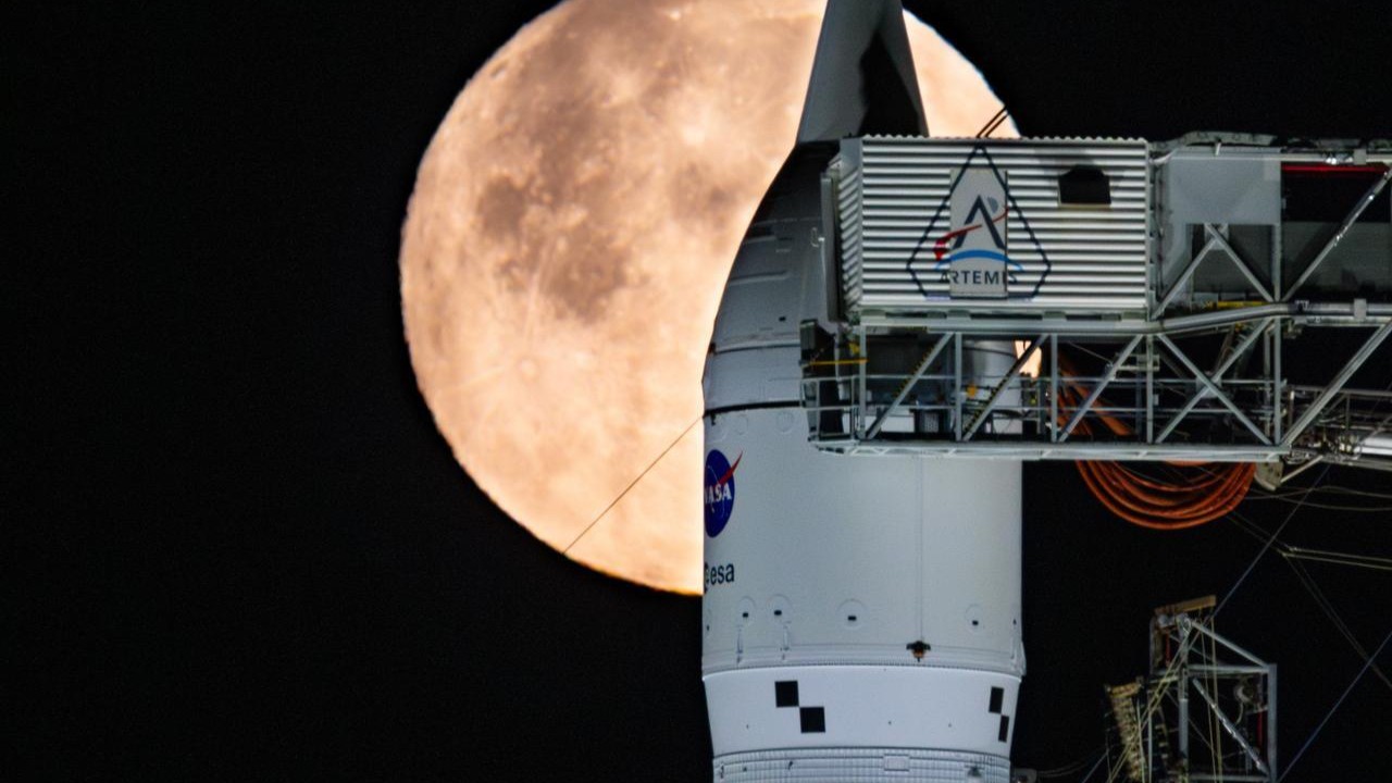NASA's Artemis 2 moon rocket in front of a full moon
