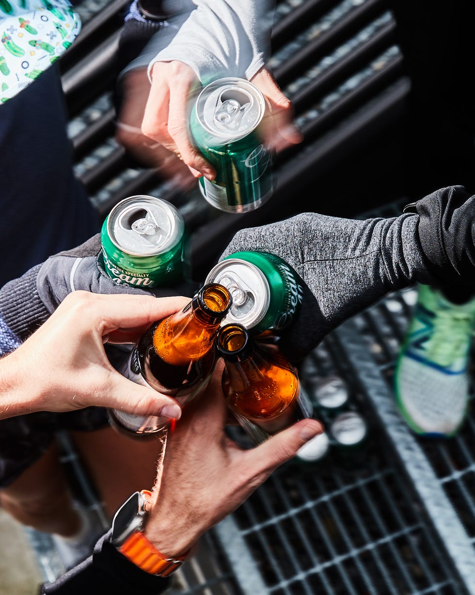 post run cheers with bottles and cans of beer