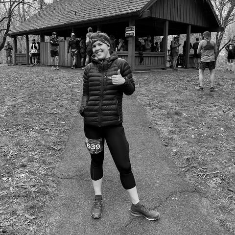 lisa slade giving thumbs up in running gear and race bib