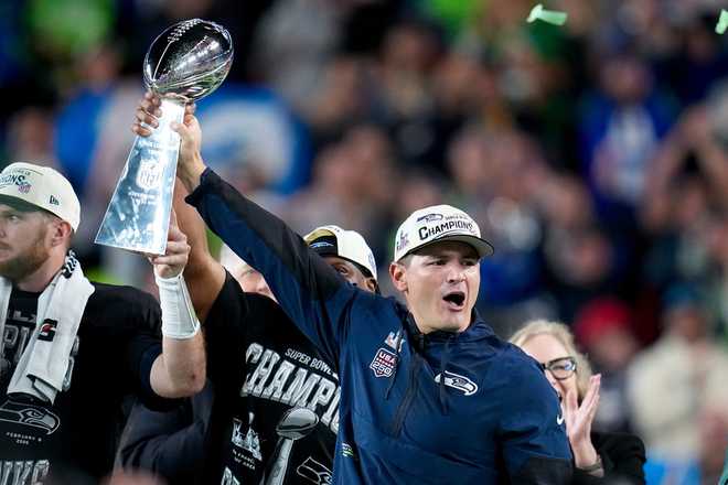 Seattle Seahawks head coach Mike MacDonald hold the Lombardi Trophy after defeating the New England Patriots the NFL Super Bowl 60 football game, Sunday, Feb. 8, 2026, in Santa Clara, Calif.
