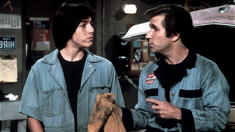 Chachi Arcola in coveralls looks at Fonzie