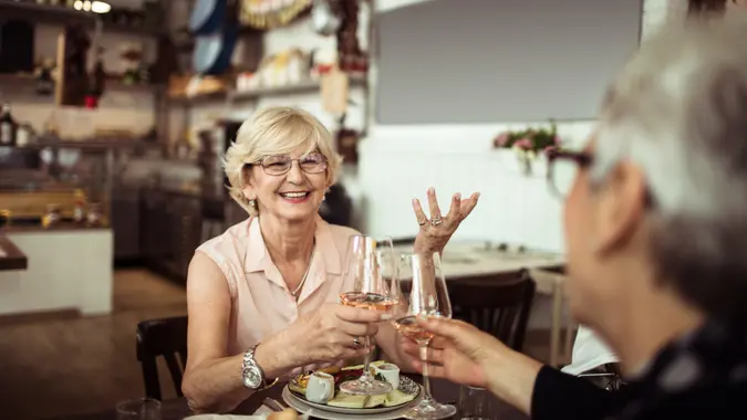 Close up of two senior friends having brunch in a local restaurant.