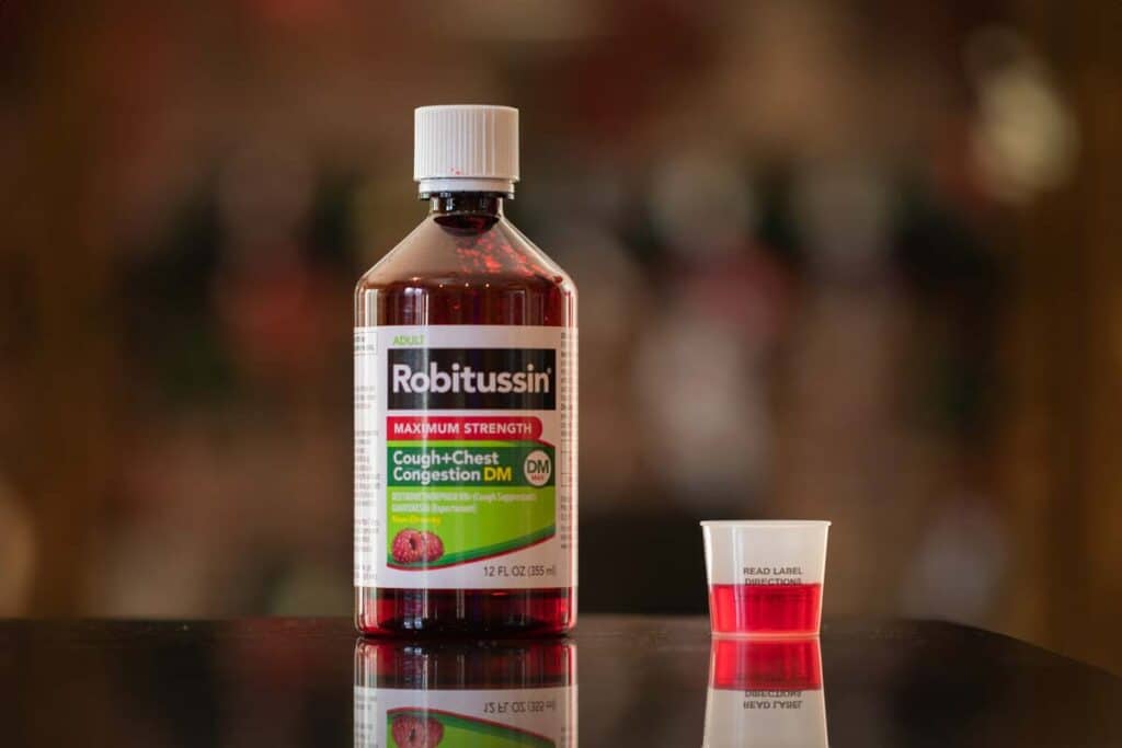 Robitussin bottle on a kitchen counter, representing Robitussin settlement.