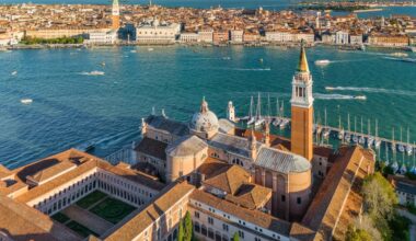 Aerial view of the Venetian lagoon showing San Giorgio Maggiore island and Grand Canal in Venice, Italy, at sunrise,