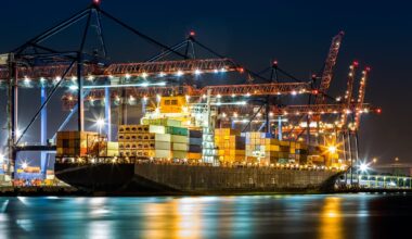 A containership being loaded at the Port of New York and New Jersey at night.
