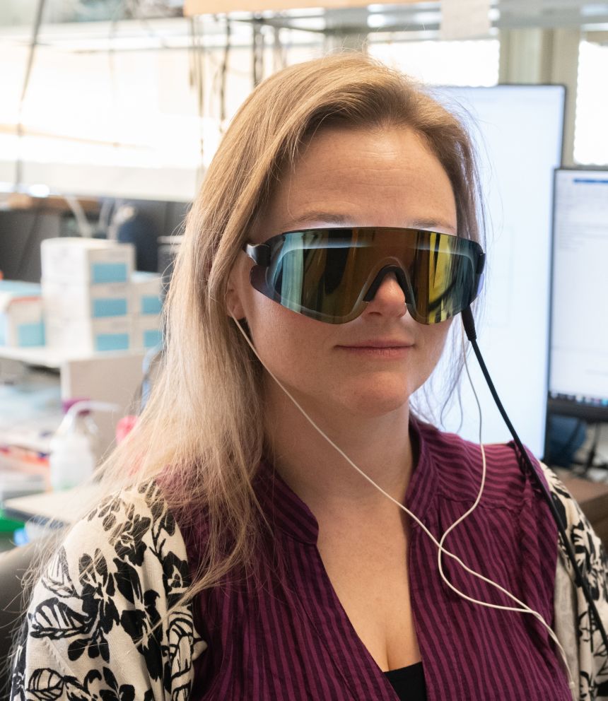 Singer has used her research to try to develop a new therapeutic treatment for Alzheimer’s disease. Here, Singer displays a prototype visor and headphones that produce 40‑Hz lights and sound.