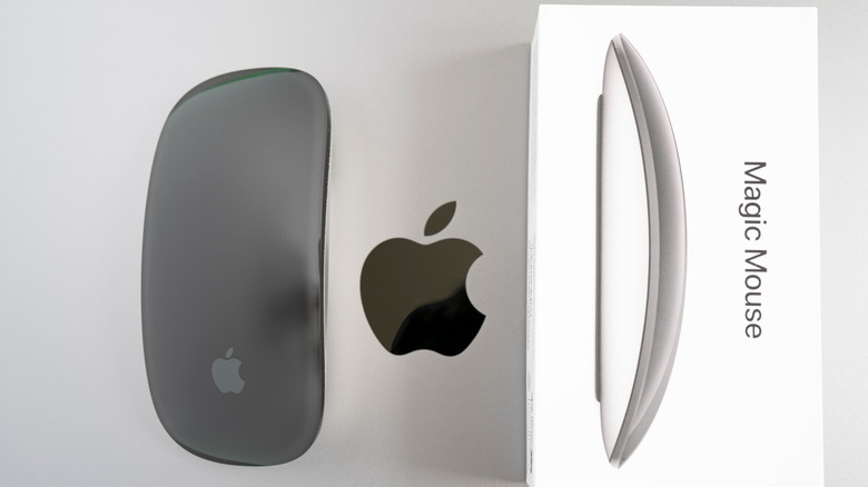 Magic Mouse unboxed and placed on a MacBook Pro