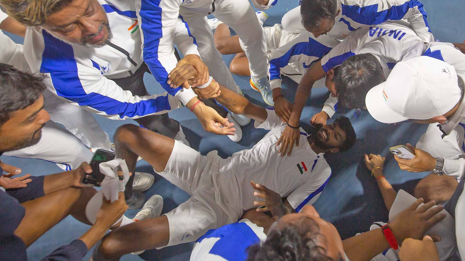 Dhakshineswar Suresh is congratulated by his teammates after securing a famous Davis Cup win for India.