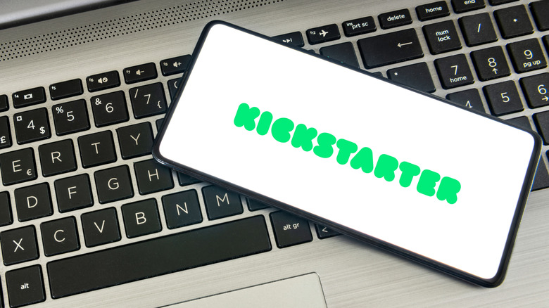 the Kickstarter logo on a phone atop a keyboard