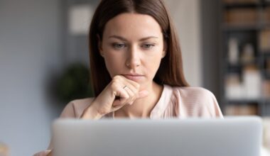 Person looking intently at laptop.