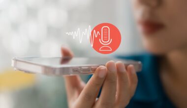 Person holding a smartphone with a voice recording icon.