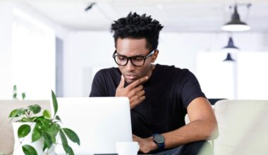 An investor working at home looks at something on a laptop.