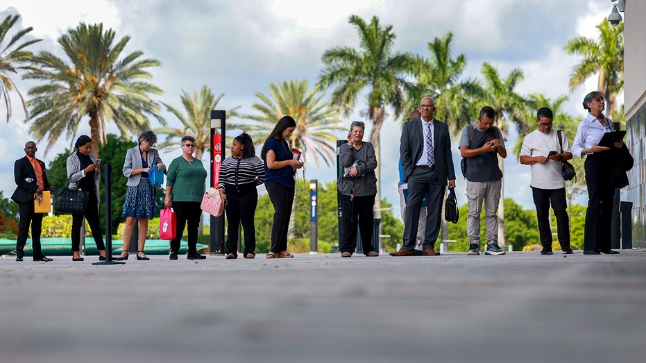 Job seekers wait in line at career fair