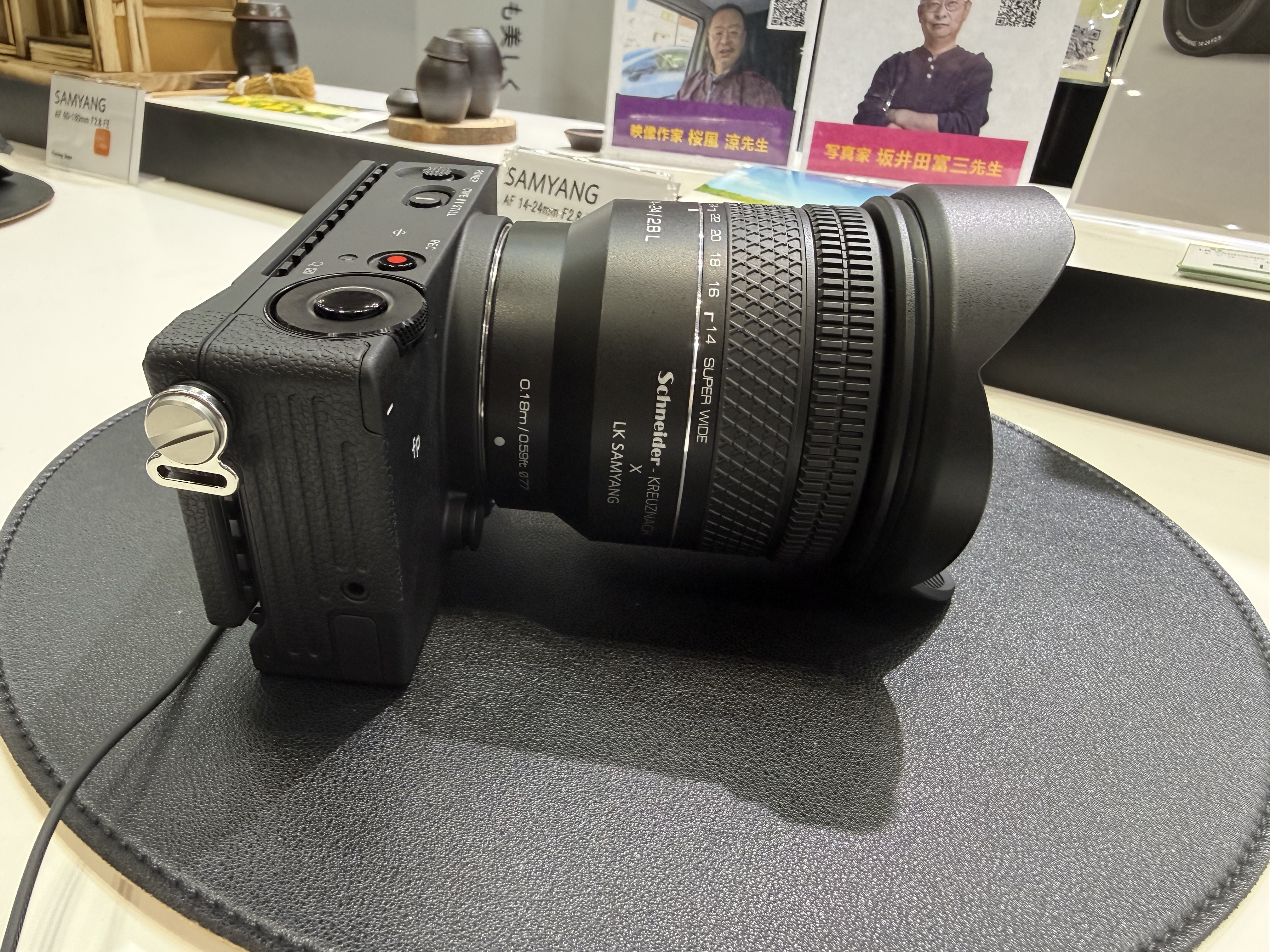A Samyang lens on display at the CP+ show, attached to a Sony camera
