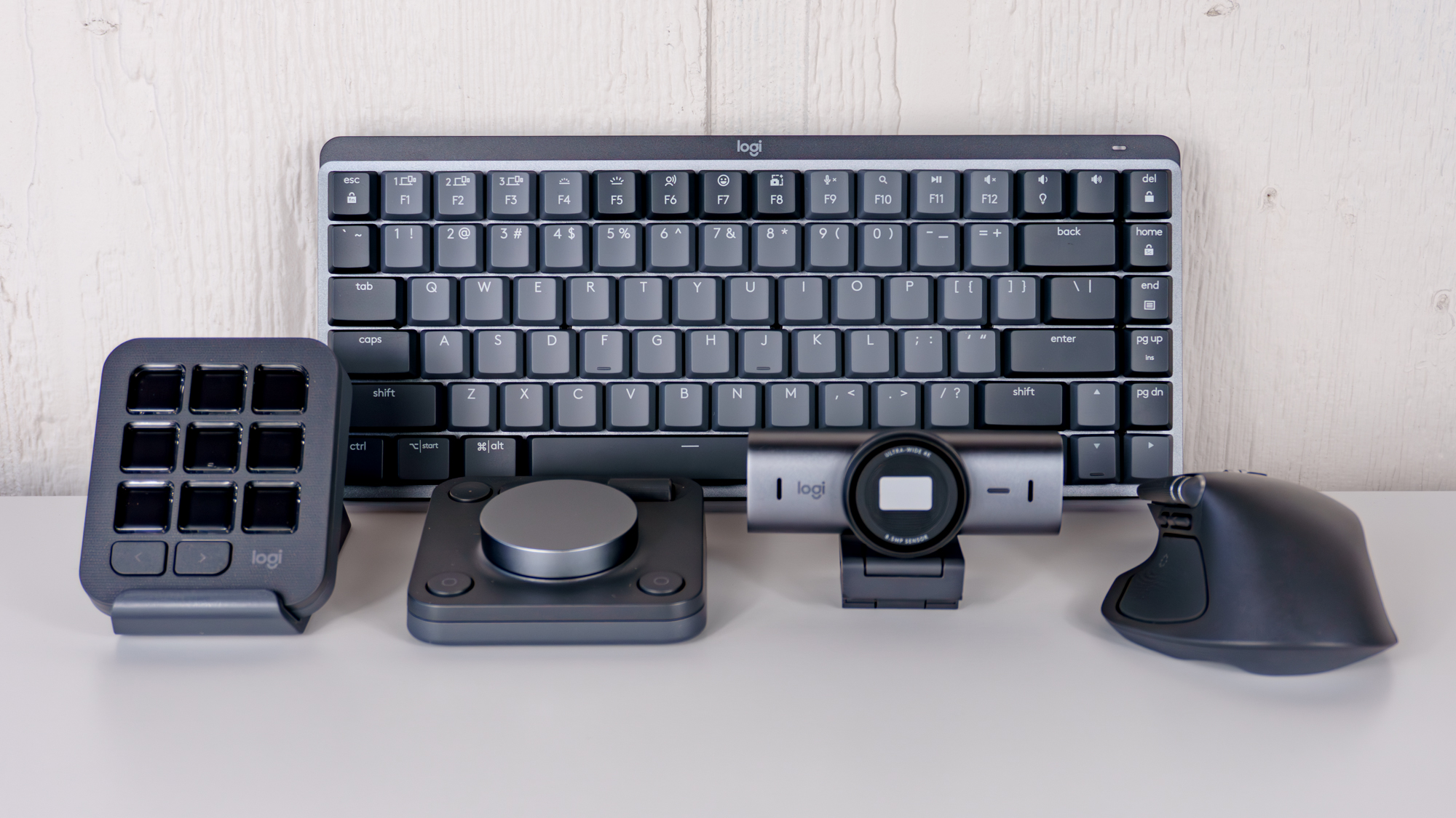 Logitech's MX Mechanical Mini keyboard, MX Master 4 mouse, MX Brio webcam and MX Creative Console together on a table