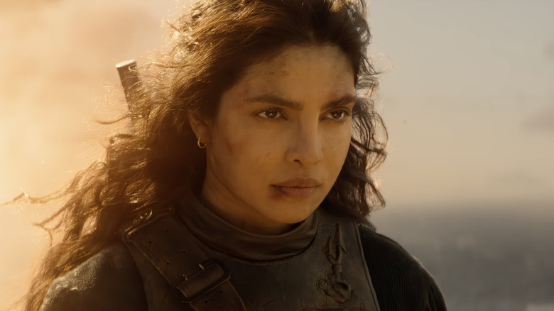 Ercell looking stoic in front of some flames in The Bluff