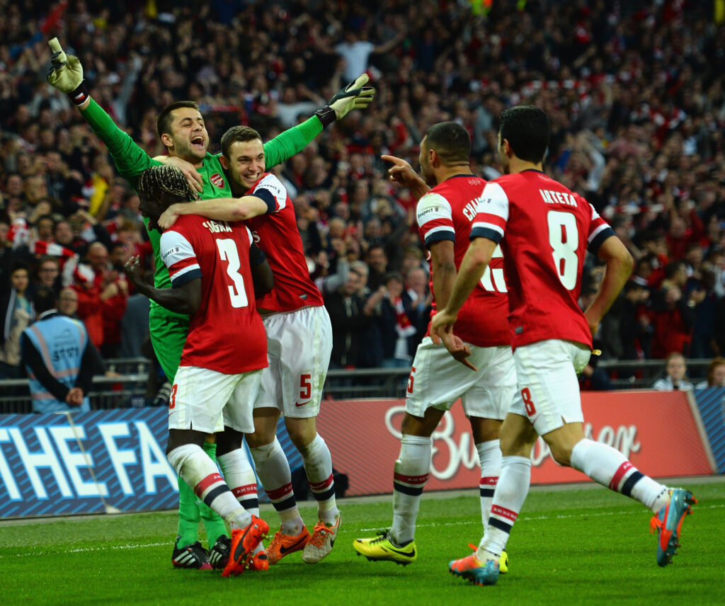 LONDON, ENGLAND - APRIL 12: Lukasz Fabianski of Arsenal celebrates winning the penalty shoot out with team mates during the FA Cup Semi-Final match between Wigan Athletic and Arsenal at Wembley Stadium on April 12, 2014 in London, England. (Photo by Shaun Botterill/Getty Images)