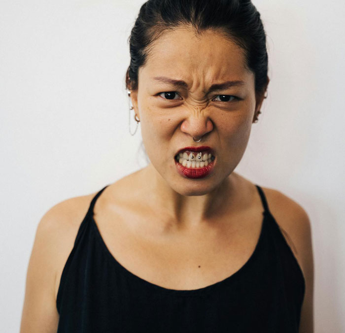 Angry woman expressing frustration, symbolizing a woman going berserk over brother meddling with her parenting. Angry woman expressing frustration, symbolizing a woman going berserk over brother meddling with her parenting.