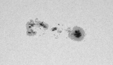 Dark sunspots are visible in a close-up view of the solar surface, which appears white.