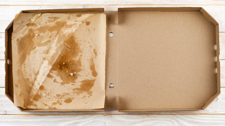 A greasy liner in an empty pizza box