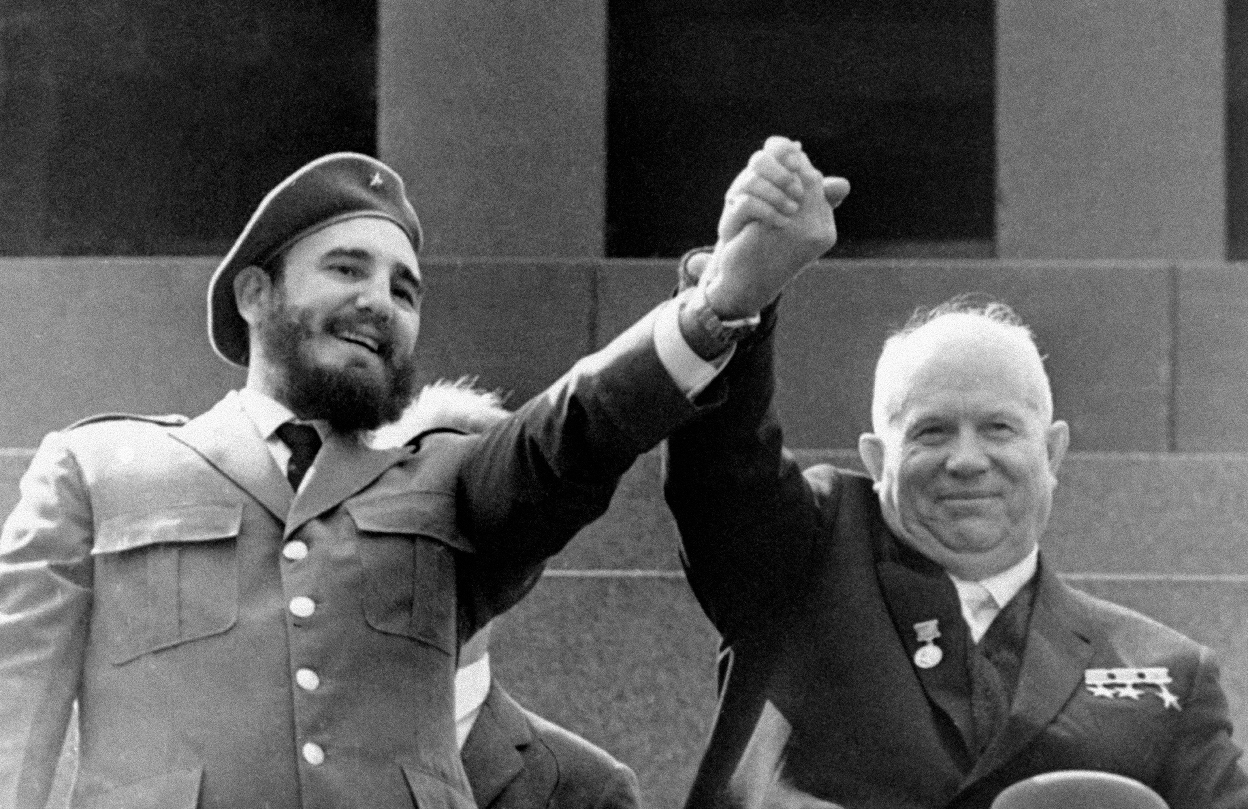 Fidel Castro and Nikita Khrushchev clasping hands.