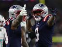 New England Patriots’ Kayshon Boutte (right) and Stefon Diggs celebrate during a game against the Miami Dolphins. 