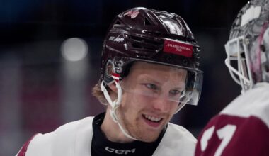 Feb 15, 2026; Milan, Italy; Dans Locmelis of Latvia greets Arturs Silovs of Latvia before their game against Denmark in men's ice hockey group C play during the Milano Cortina 2026 Olympic Winter Games at Milano Rho Ice Hockey Arena. Mandatory Credit: Amber Searls-Imagn Images