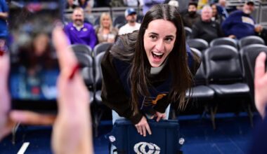Mar 25, 2026; Indianapolis, Indiana, USA; Indiana Fever guard Caitlin Clark reacts to her logo being on the back of her court chair before the game between the Indiana Pacers and the Los Angeles Lakers at Gainbridge Fieldhouse. Mandatory Credit: Marc Lebryk-Imagn Images