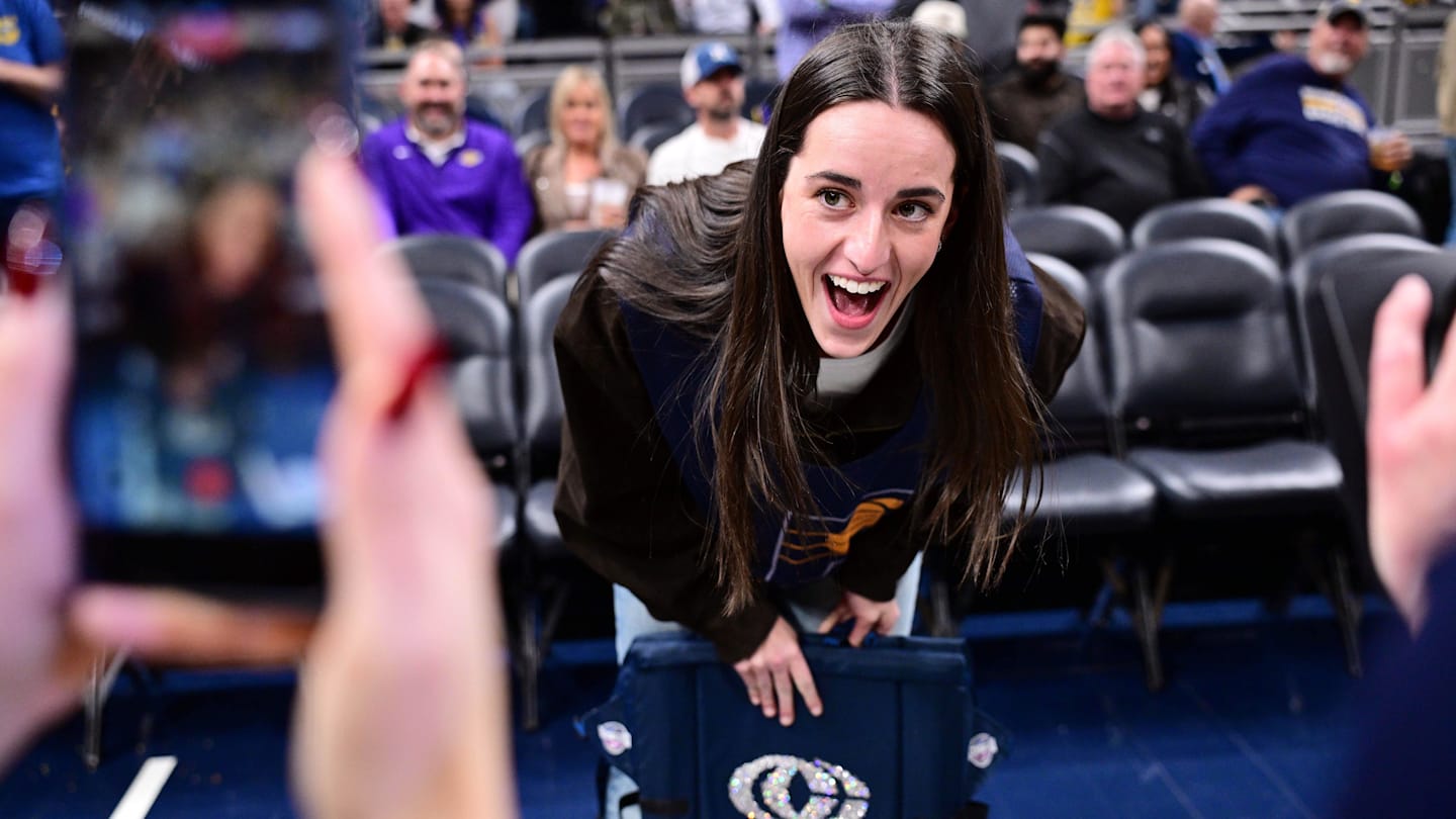 Mar 25, 2026; Indianapolis, Indiana, USA; Indiana Fever guard Caitlin Clark reacts to her logo being on the back of her court chair before the game between the Indiana Pacers and the Los Angeles Lakers at Gainbridge Fieldhouse. Mandatory Credit: Marc Lebryk-Imagn Images