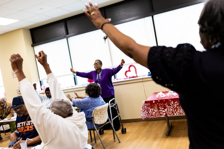 People doing exercises in a room. 