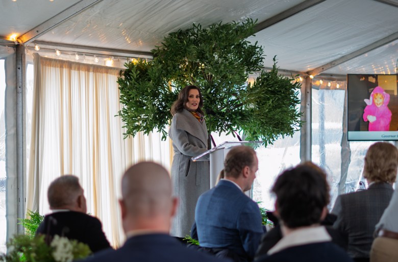 Gov. Whitmer addresses a group inside a tent-like facility.