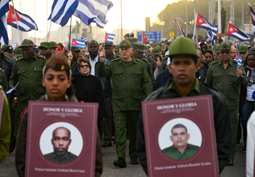 Cuba's President Miguel Diaz-Canel, center, takes part in a protest against the US incursion in Venezuela in front of the US Embassy in Havana on January 16.