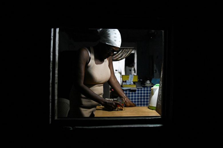 A woman sells coffee from the window of her home during a blackout in Havana on March 4.