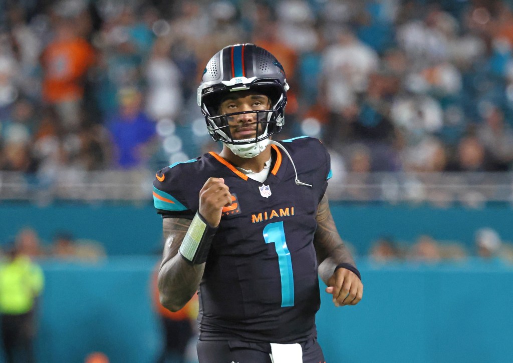 Tua Tagovailoa celebrating a touchdown pass during a New York Jets vs. Miami Dolphins game.