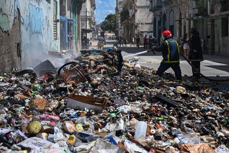 Firefighters work to put out a fire at a garbage dumping site in Havana on March 16.