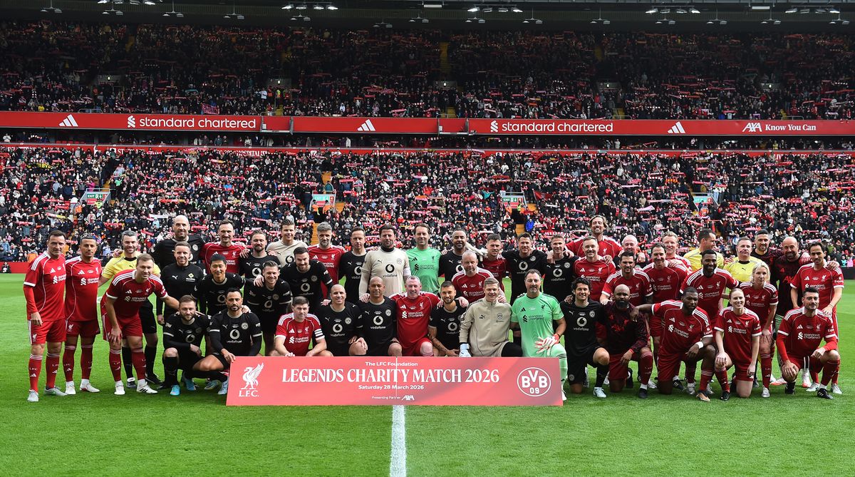 Teams pose for a joint team photo ahead of the Legends football match between Liverpool Legends and Dortmund Legends.