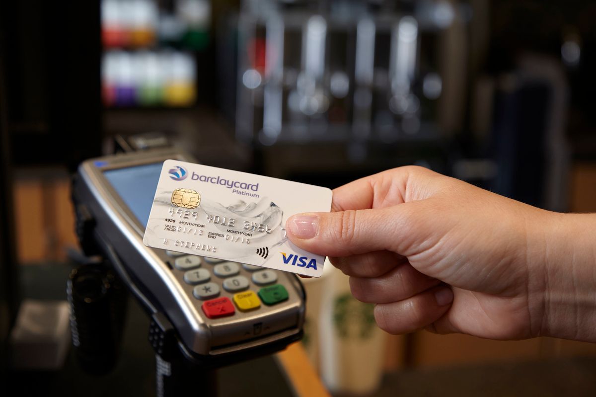 Visa card being used to make a contactless payment