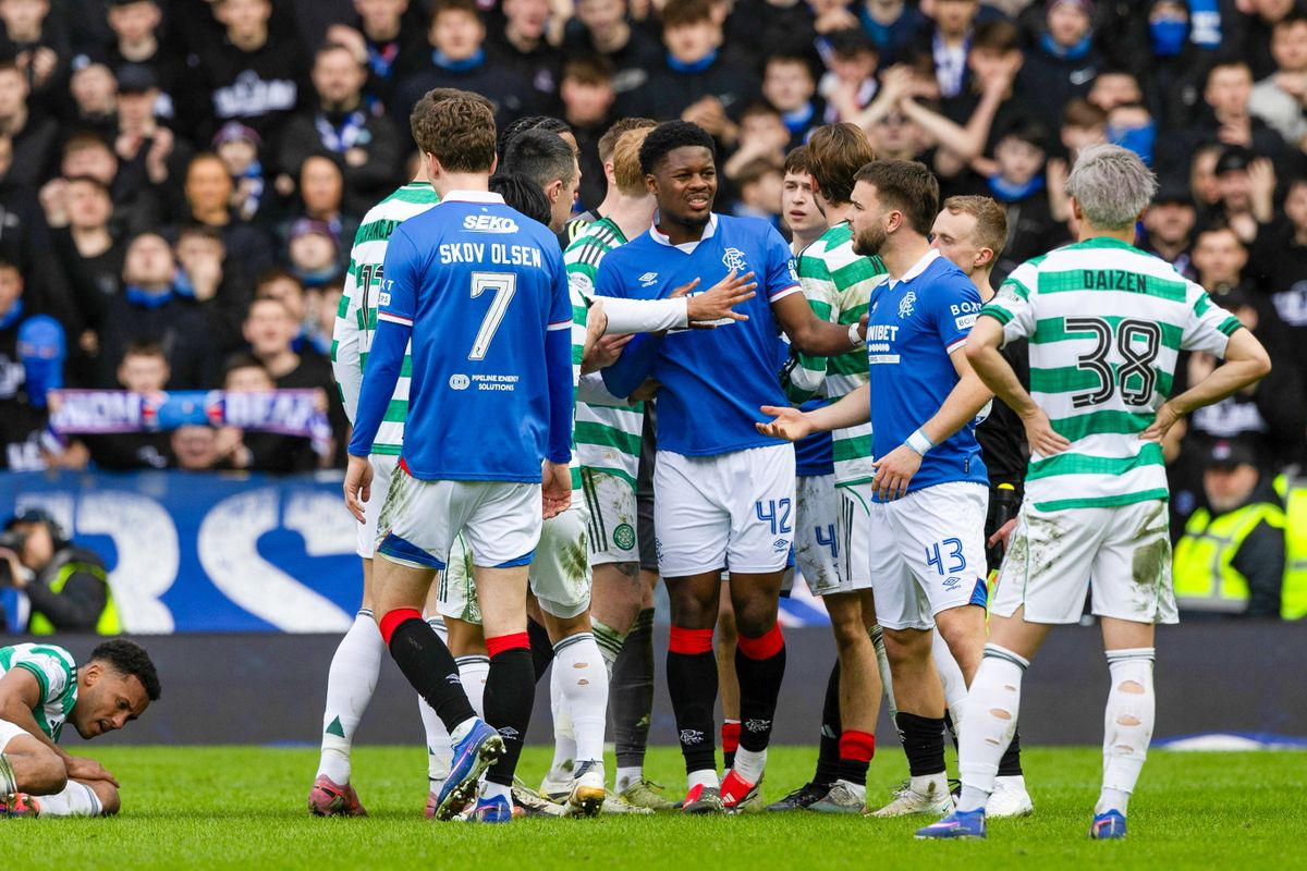 Celtic's Auston Trusty goes down due to an off the ball incident with Rangers' Youssef Chermiti