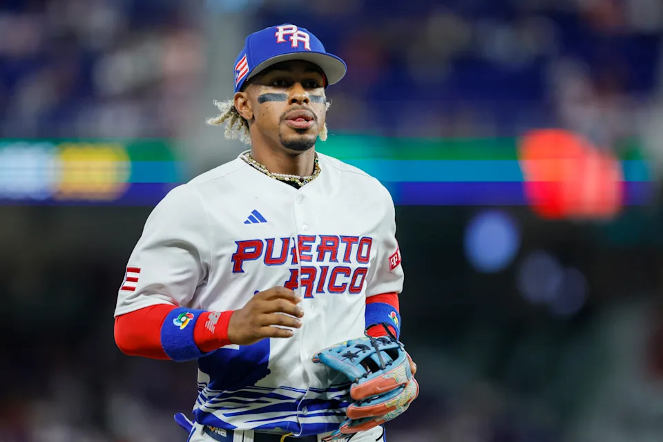 Puerto Rico shortstop Francisco Lindor (12) runs toward the dugout during the first inning against Israel on March 13, 2023, at LoanDepot Park in Miami, Florida.