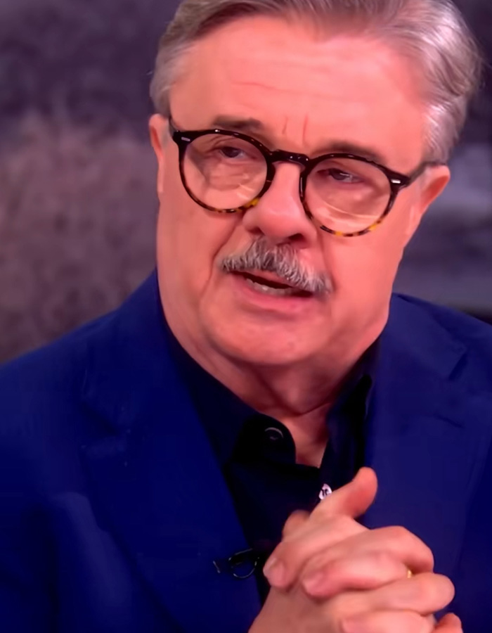 Older man with glasses in a navy jacket discussing Timothée Chalamet as a sage ahead of the Oscars in an interview setting. Older man with glasses in a navy jacket discussing Timothée Chalamet as a sage ahead of the Oscars in an interview setting.