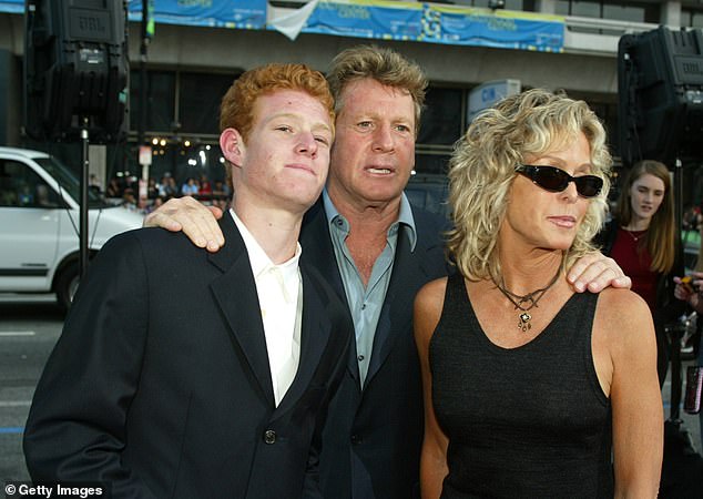 Actor Ryan O'Neal (center) and Farrah Fawcett (right) pictured with their only son, Redmond (left) at the premiere for the movie Malibu's Most Wanted in April 10, 2003