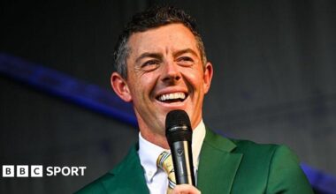 Rory McIlroy smiles during a Q&A session at the Irish Open in 2025, while wearing the green jacket he received after winning The Masters