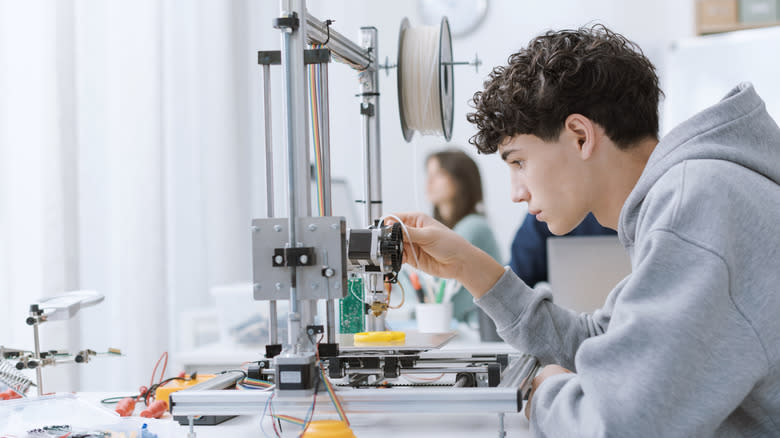 Person using a 3D printer