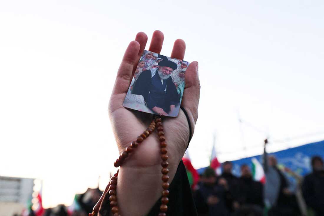 A person holds a picture of Iran's supreme leader Ayatollah Ali Khamenei, who was killed in joint US and Israeli strikes, as people mourn at a square in Tehran on March 1, 2026.
