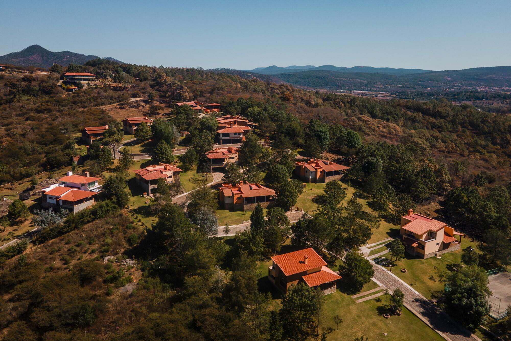 An aerial view of cabins surrounded by forest at the La Loma complex